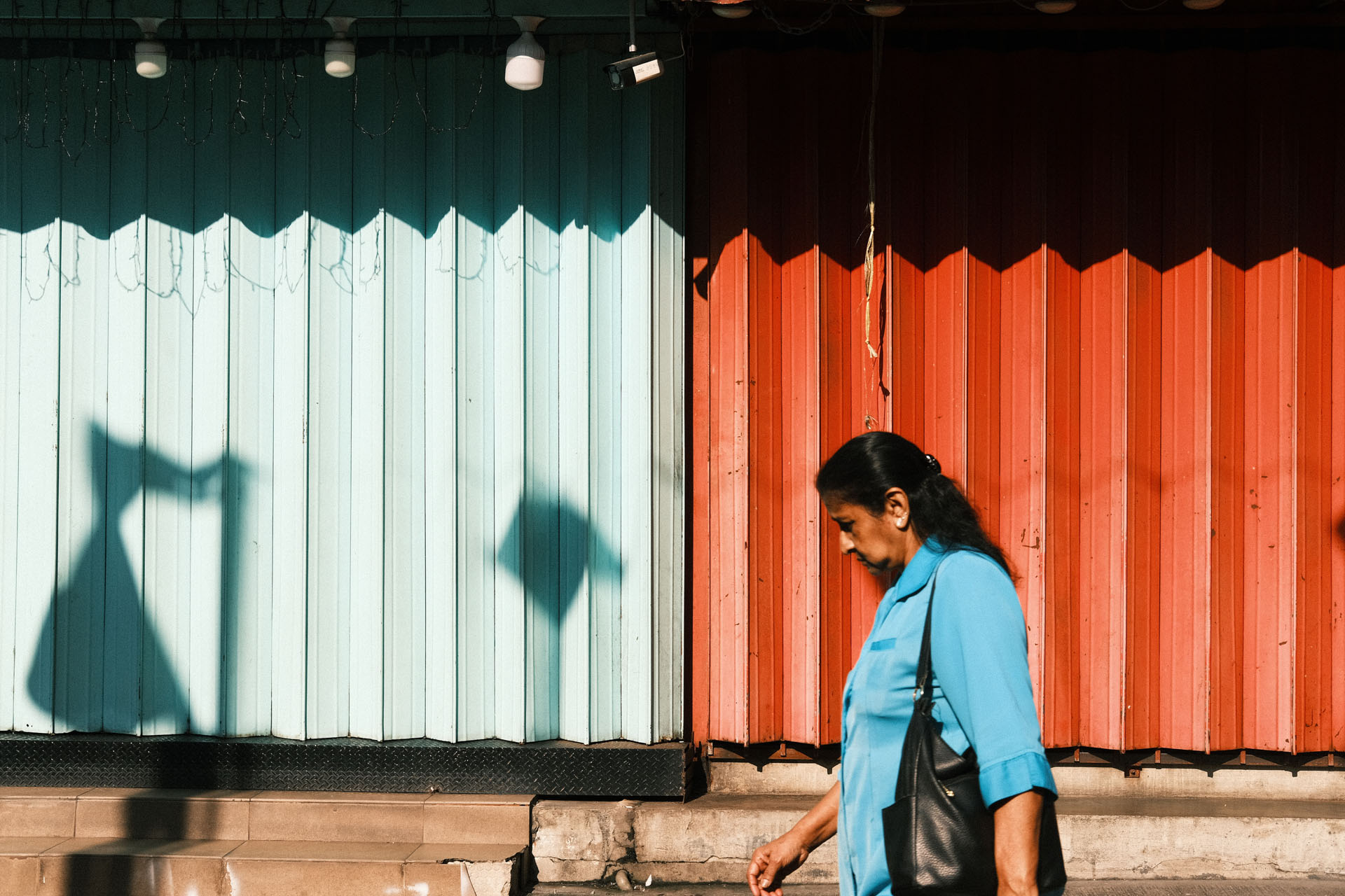 Kodak Gold 200 Film Recipe Summer - A woman walk pass colorful shoplot