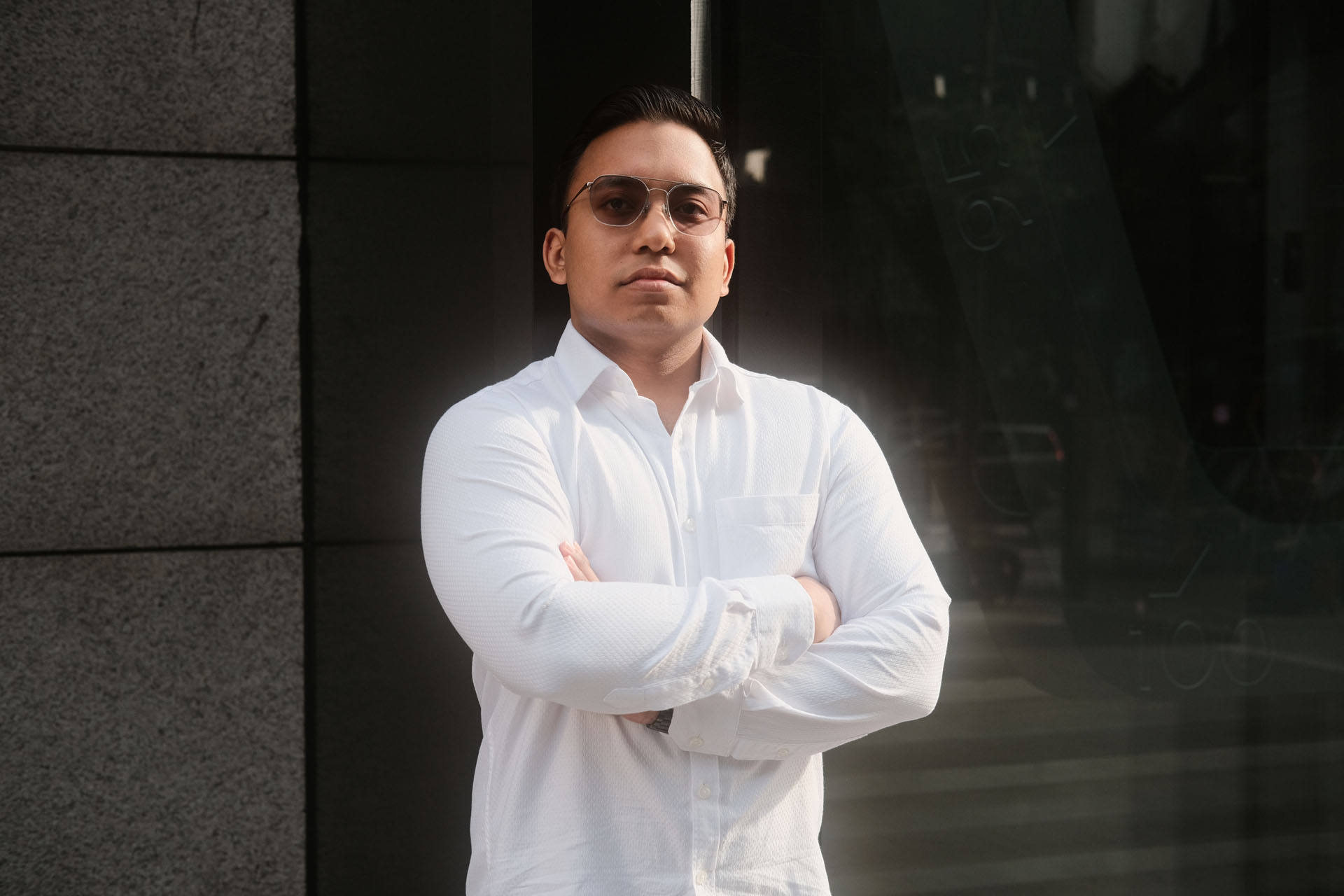 Confident arms-crossed pose for male portrait