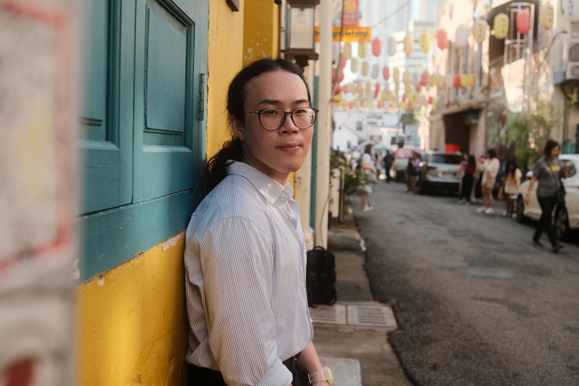 Leaning against wall pose for men with city background