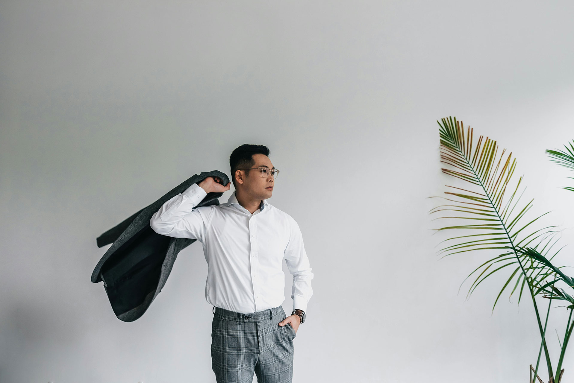 Man carrying jacket over shoulder in lifestyle photo