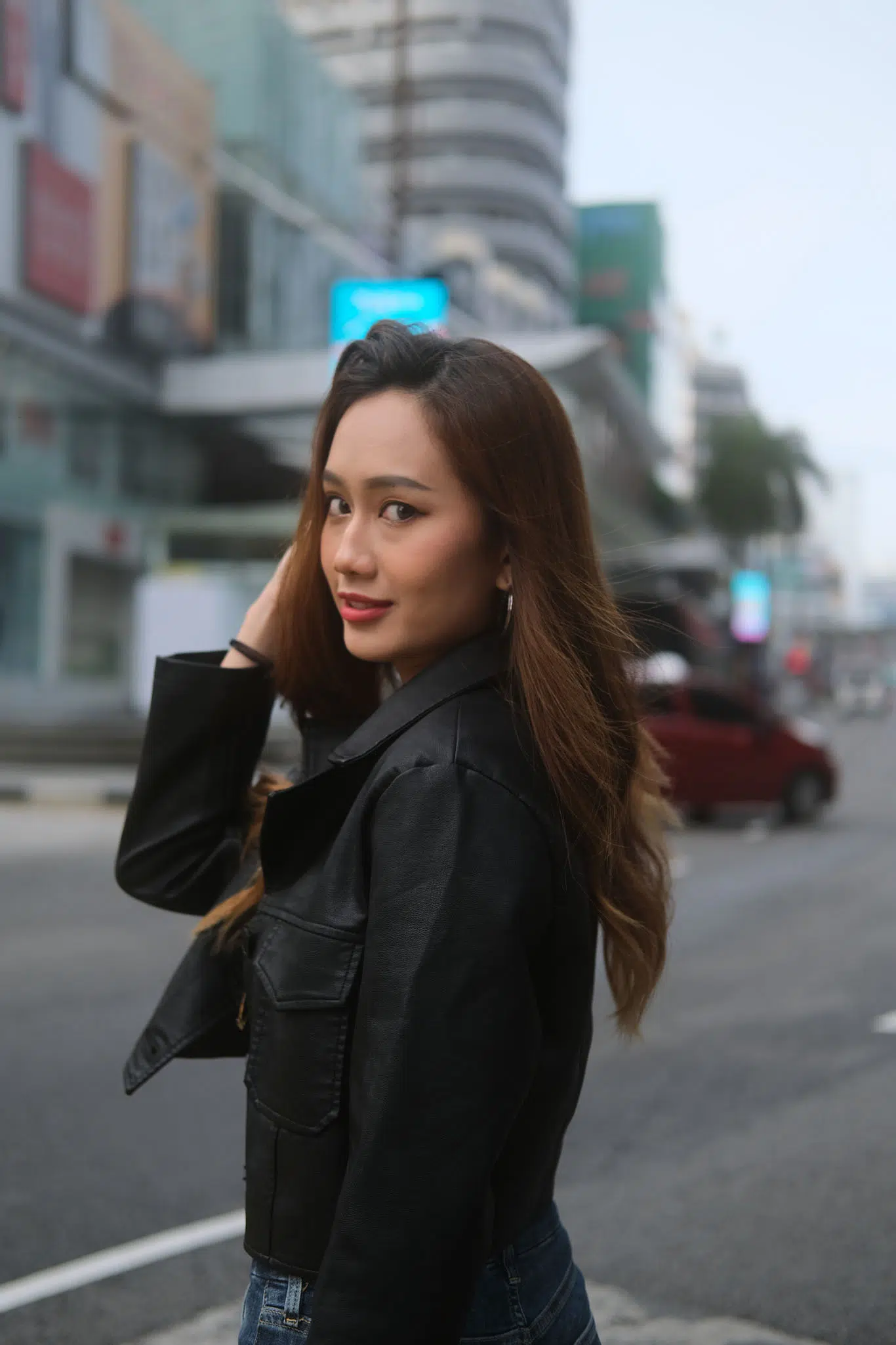 Woman walking slowly, turning her head back toward the camera, mid-step—adds movement and emotion to a walking pose for women