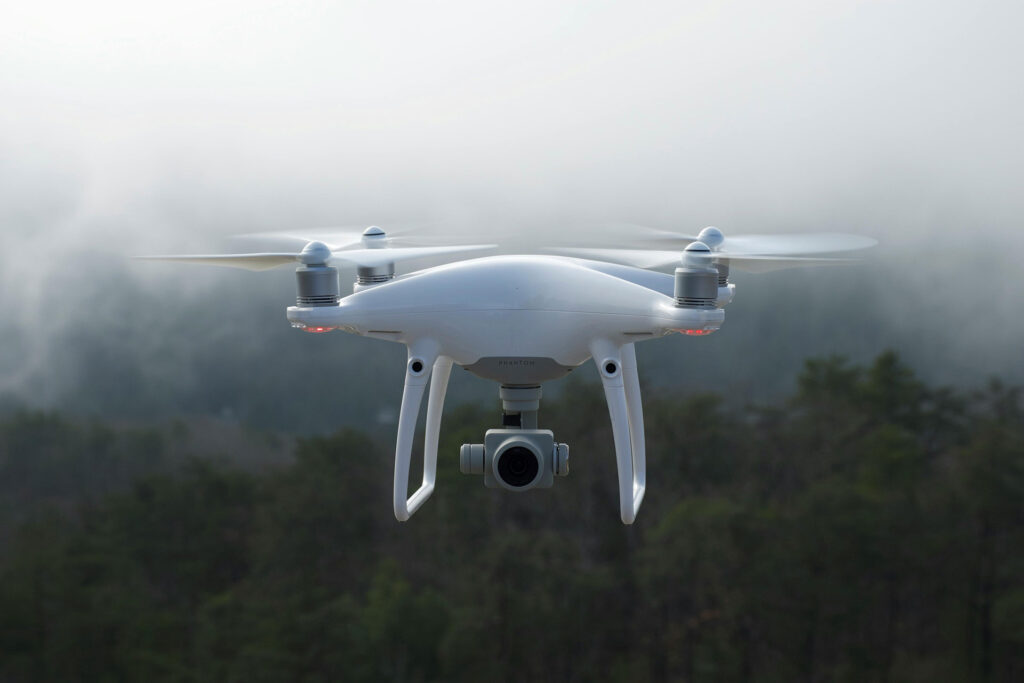 Best Camera Drones - Flying Drone with forest background