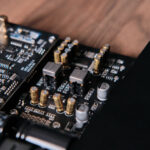 Angled shot of the amplifier’s internal components with Oracle II-02 op amps and surrounding capacitors visible